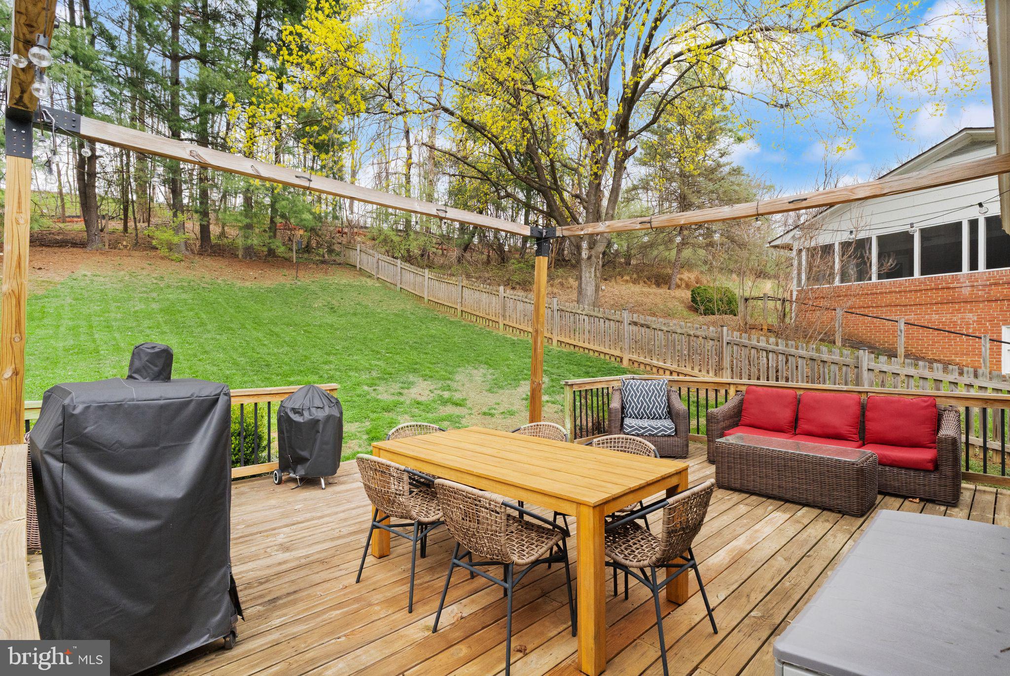 413 George Street Winchester, VA 22601 - Photo 41 of 54 a view of a patio with couches table and chairs and potted plants with wooden floor and fence