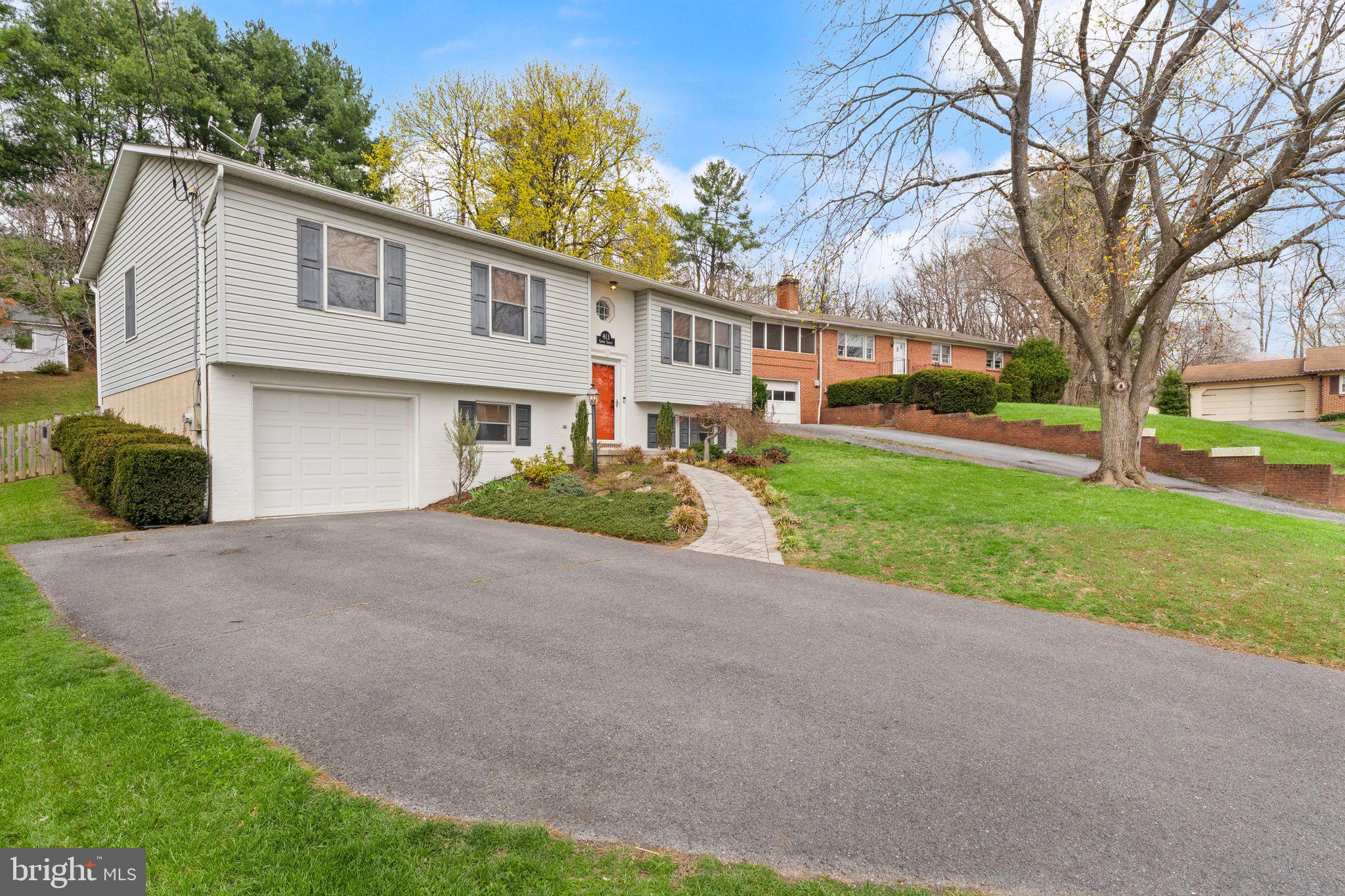 413 George Street Winchester, VA 22601 - Photo 5 of 54 a front view of a house with a yard and garage