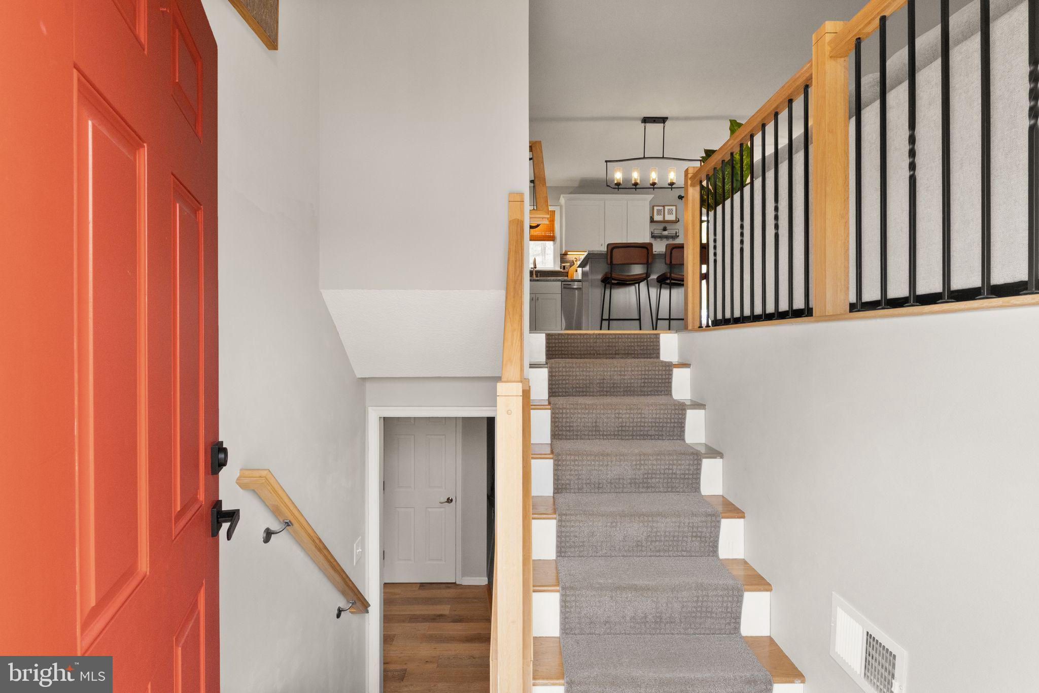413 George Street Winchester, VA 22601 - Photo 7 of 54 a view of staircase with lots of frames on wall and a window