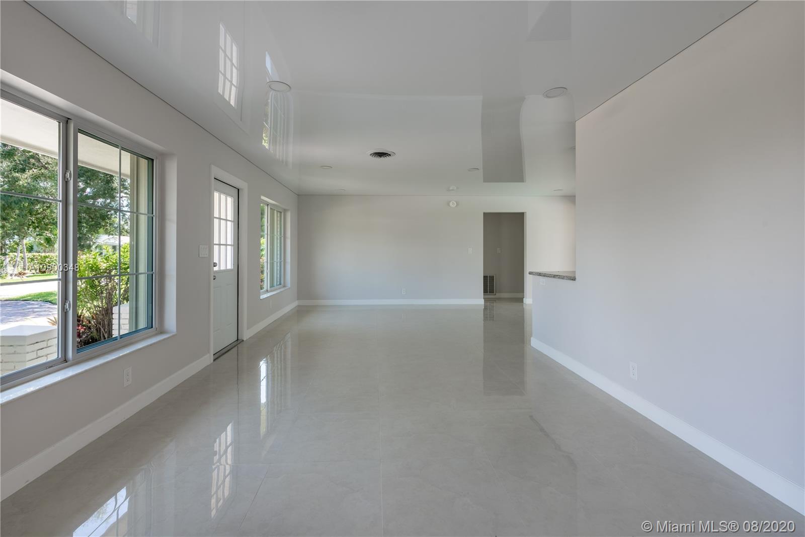 2630 Northeast 51st Court Lighthouse Point, FL 33064 - Photo 12 of 43 a view of a big room with windows and chandelier fan
