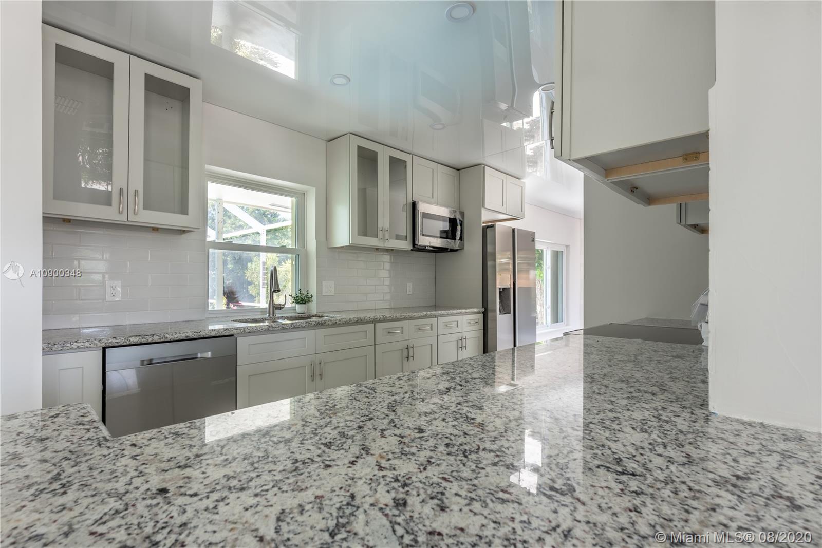 2630 Northeast 51st Court Lighthouse Point, FL 33064 - Photo 20 of 43 a kitchen with stainless steel appliances granite countertop a sink stove and refrigerator