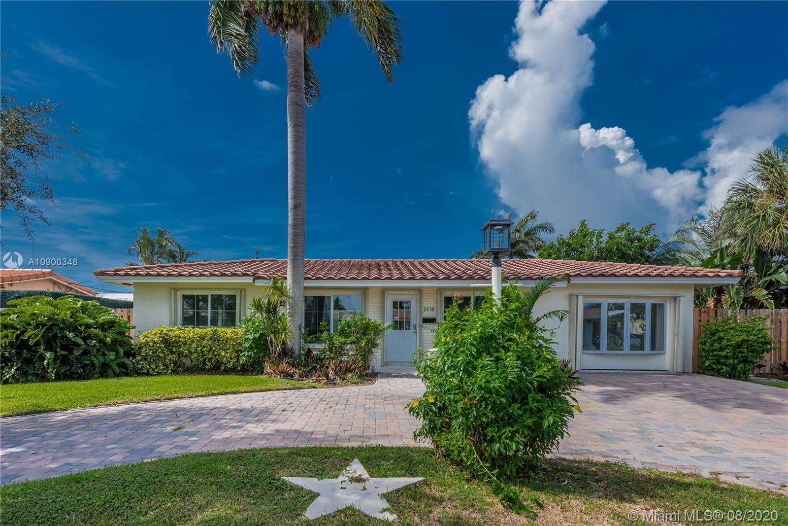 2630 Northeast 51st Court Lighthouse Point, FL 33064 - Photo 3 of 43 a view of a house with a yard