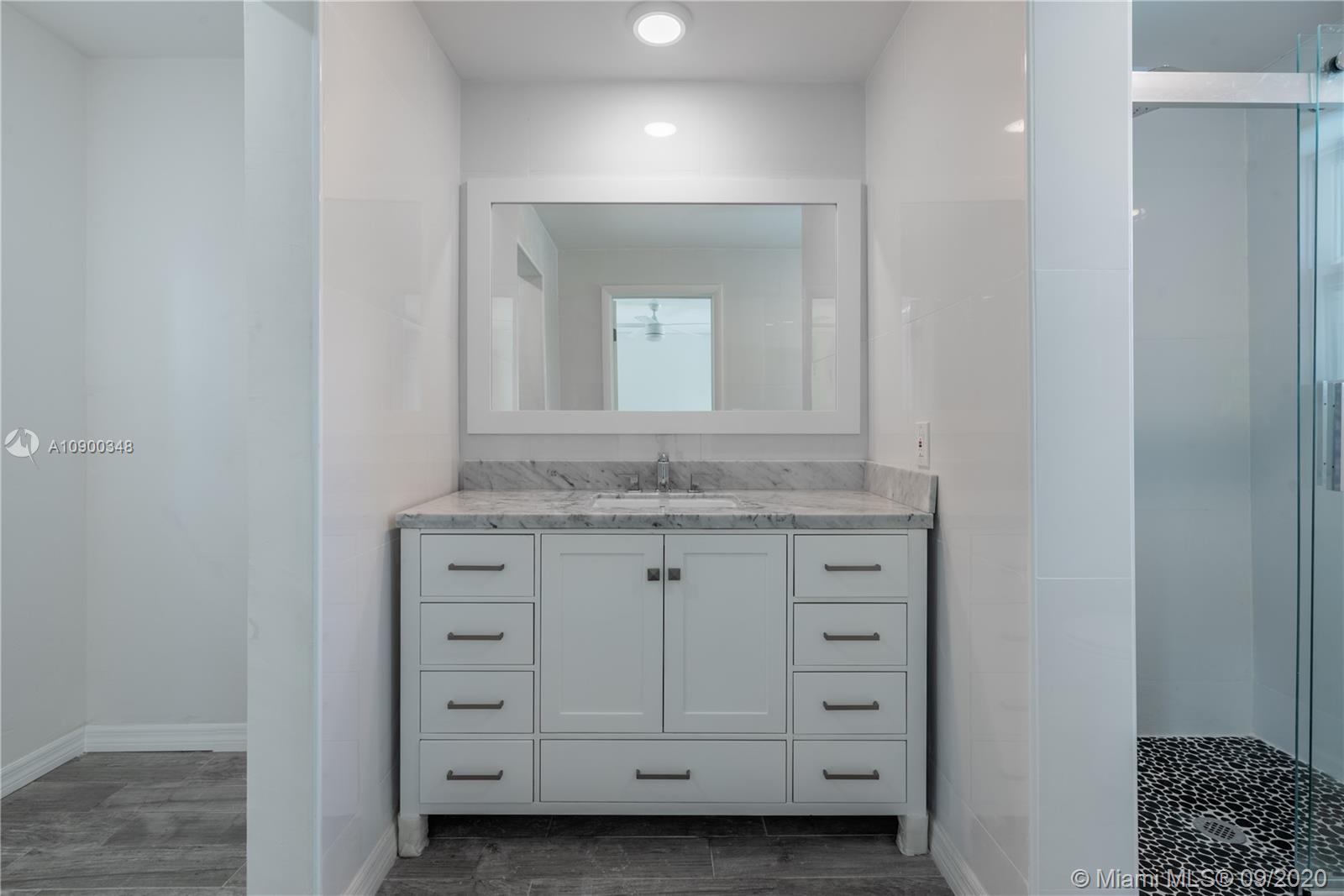 2630 Northeast 51st Court Lighthouse Point, FL 33064 - Photo 32 of 43 a bathroom with a granite countertop sink and a mirror