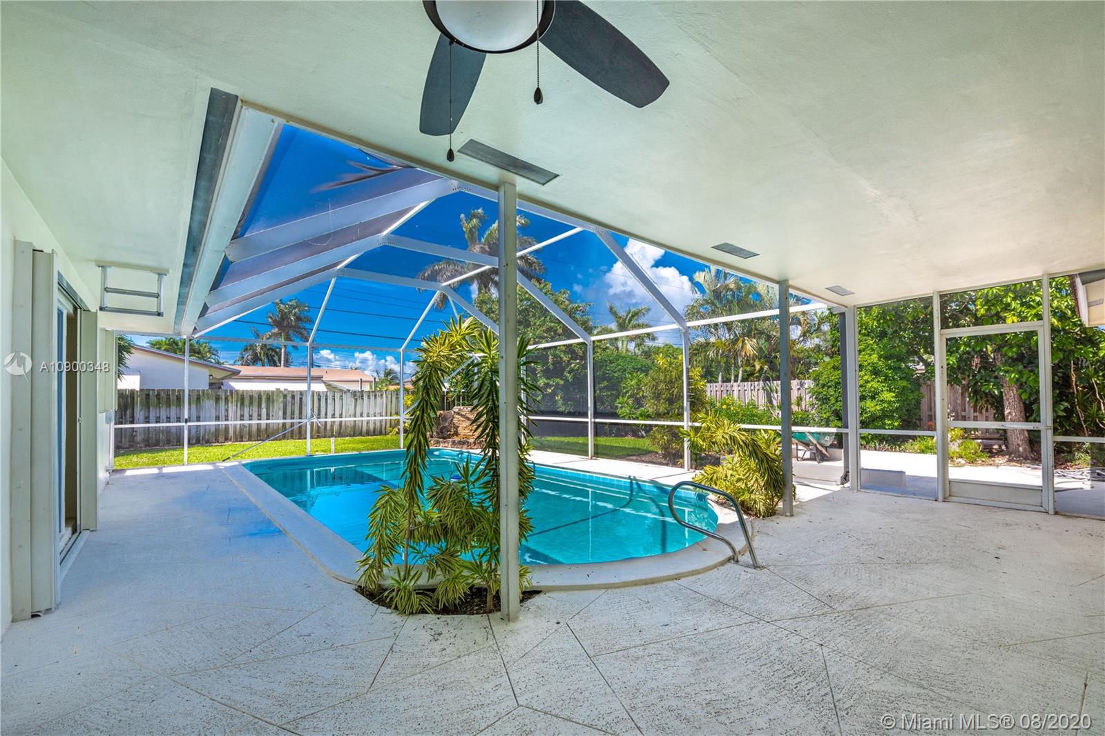 2630 Northeast 51st Court Lighthouse Point, FL 33064 - Photo 34 of 43 a view of a swimming pool with a lounge chair and a basket ball poll