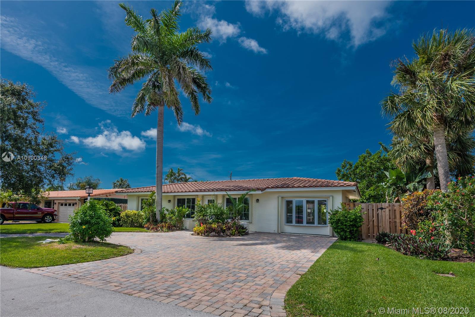 2630 Northeast 51st Court Lighthouse Point, FL 33064 - Photo 5 of 43 a front view of a house with garden