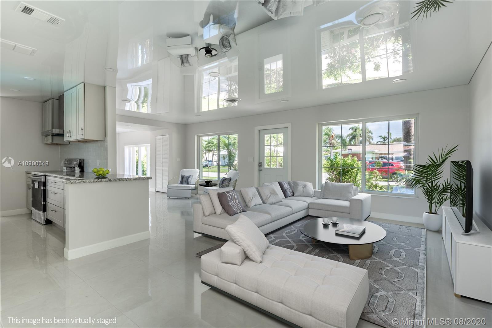 2630 Northeast 51st Court Lighthouse Point, FL 33064 - Photo 8 of 43 a living room with furniture and a large window