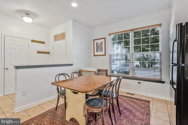 a view of a dining room with furniture and a window