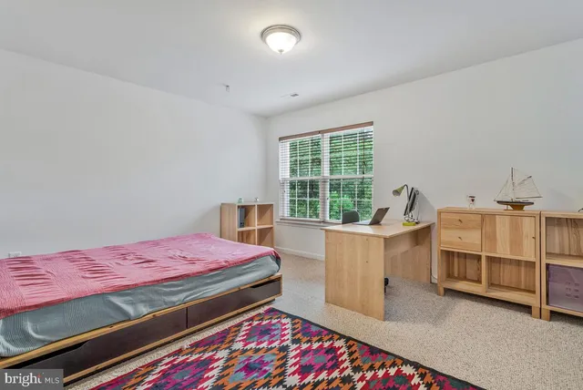 a bed room with a bed and a window