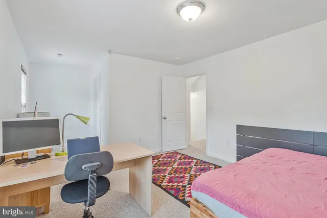 a bedroom with a bed and a desk