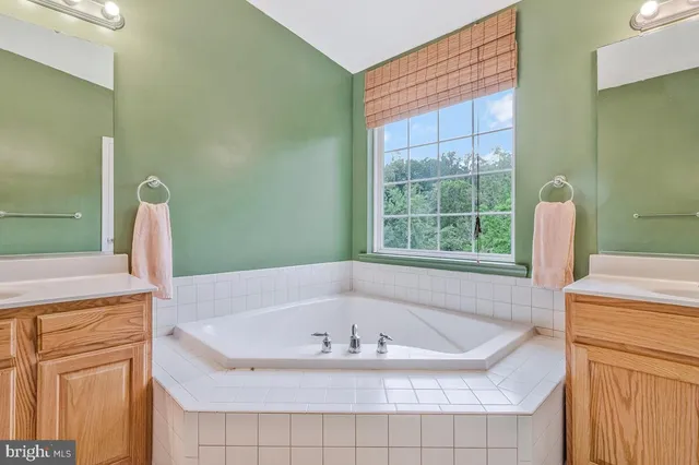 a bath tub sitting in a bathroom next to a window
