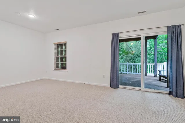 a view of an empty room with a balcony