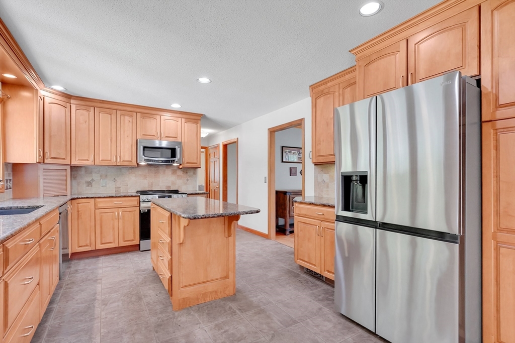 5 Evergreen Circle Wilbraham, MA 01095 - Photo 11 of 39 a kitchen with stainless steel appliances granite countertop a refrigerator and a stove top oven