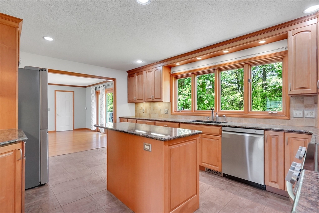 5 Evergreen Circle Wilbraham, MA 01095 - Photo 13 of 39 a kitchen with stainless steel appliances granite countertop a sink and cabinets