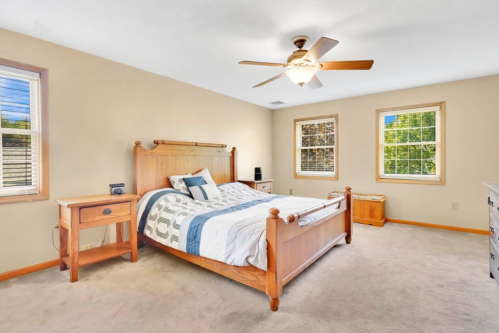 5 Evergreen Circle Wilbraham, MA 01095 - Photo 18 of 39 a bed room with a bed and a chandelier