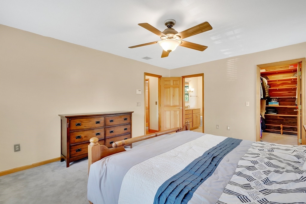 5 Evergreen Circle Wilbraham, MA 01095 - Photo 20 of 39 a bedroom with a bed and a chandelier