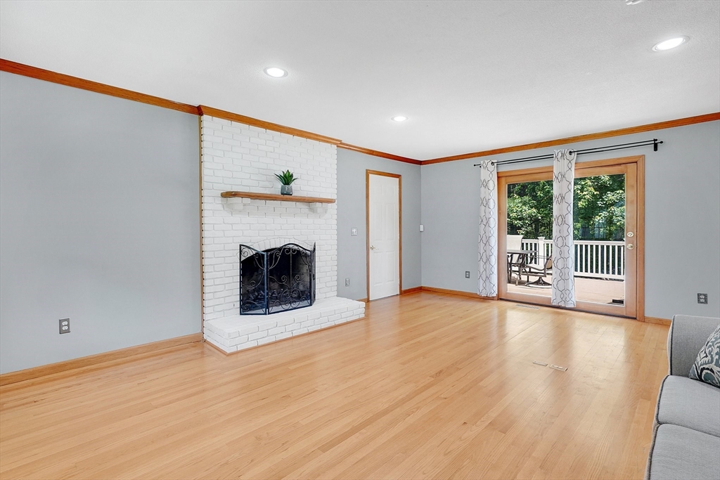 5 Evergreen Circle Wilbraham, MA 01095 - Photo 6 of 39 a view of an empty room with a fireplace and a window