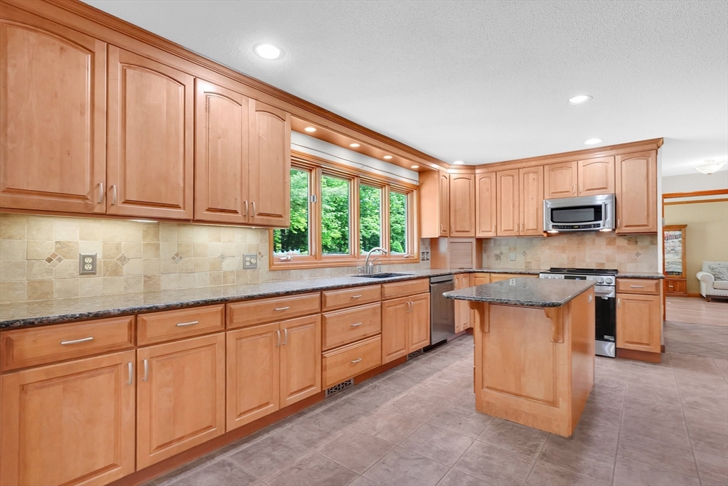 5 Evergreen Circle Wilbraham, MA 01095 - Photo 10 of 39 a kitchen with stainless steel appliances granite countertop a stove a sink and a microwave
