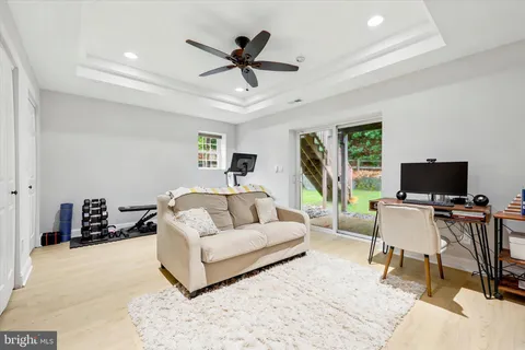 a living room with furniture and a flat screen tv with wooden floor