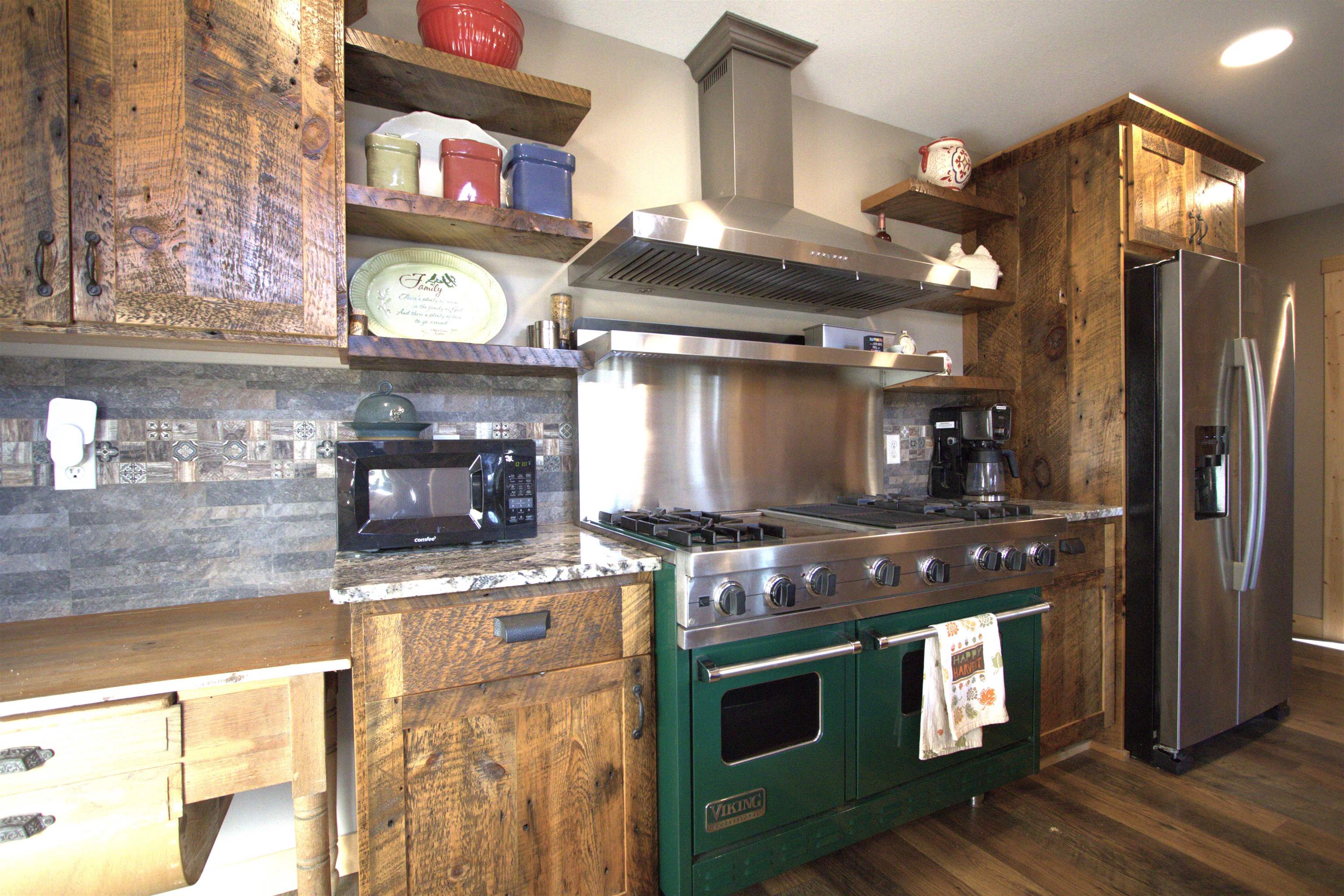 6014 Brown Road Kettle River, MN 55757 - Photo 14 of 54 Kitchen featuring open shelves, double oven range, wall chimney range hood, stainless steel fridge, and black microwave