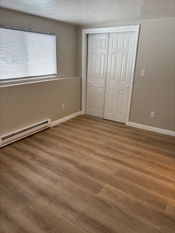2 Tideview Path, Unit 8 Plymouth, MA 02360 - Photo 11 of 16 a view of an empty room with wooden floor and a window