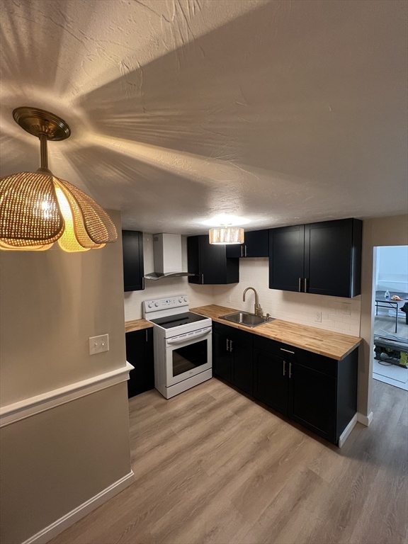 2 Tideview Path, Unit 8 Plymouth, MA 02360 - Photo 3 of 16 a large kitchen with stainless steel appliances a stove and a refrigerator