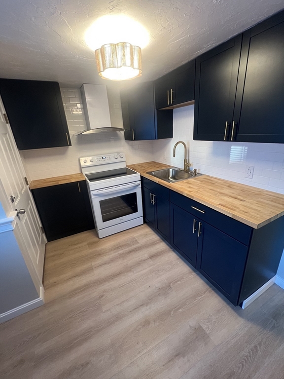 2 Tideview Path, Unit 8 Plymouth, MA 02360 - Photo 5 of 16 a large kitchen with stainless steel appliances wooden cabinets and a sink