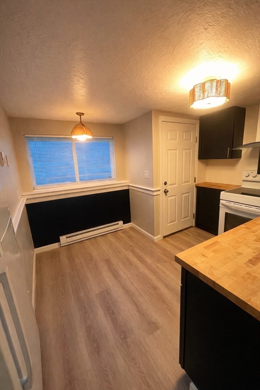 2 Tideview Path, Unit 8 Plymouth, MA 02360 - Photo 6 of 16 a kitchen with a table chairs and refrigerator