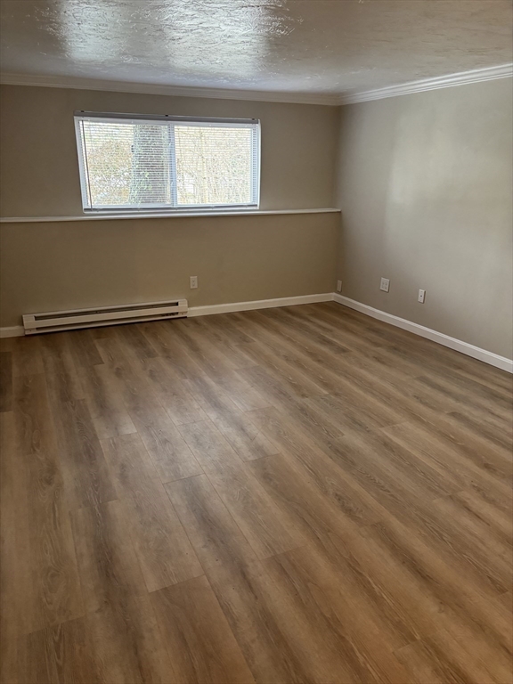 2 Tideview Path, Unit 8 Plymouth, MA 02360 - Photo 9 of 16 a view of an empty room with wooden floor and a window