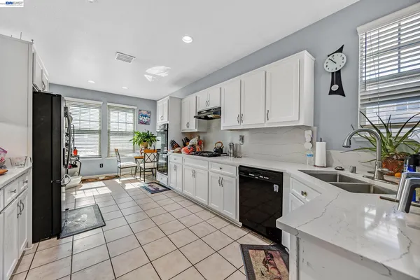 a kitchen with a sink cabinets and window