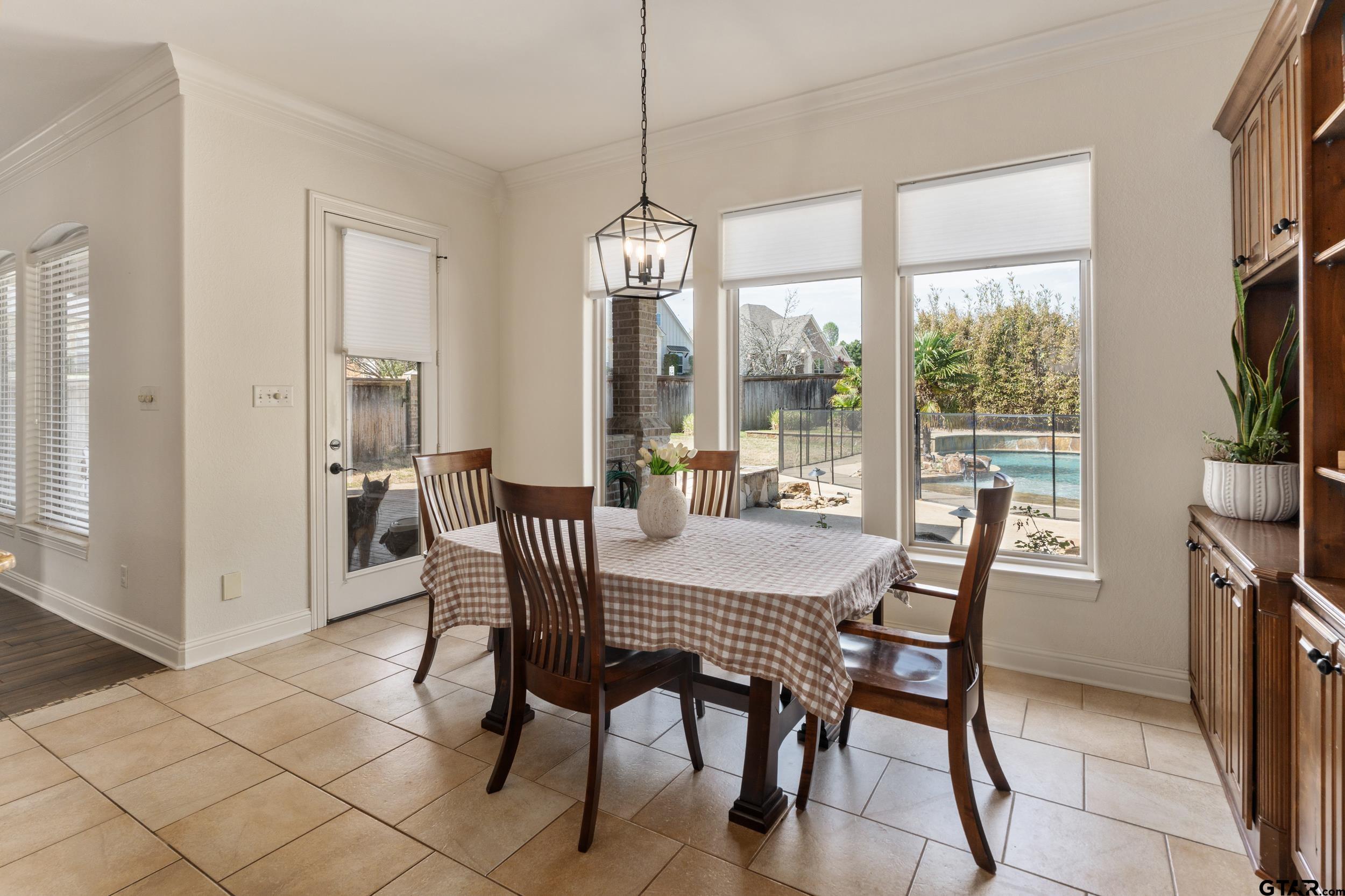 1509 Cooks Crossing Tyler, TX 75703 - Photo 15 of 48 a view of a dining room with furniture large windows and wooden floor