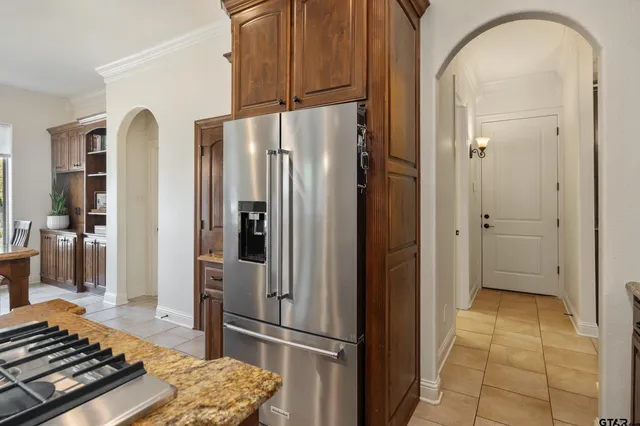 a kitchen with stainless steel appliances granite countertop a refrigerator and a stove