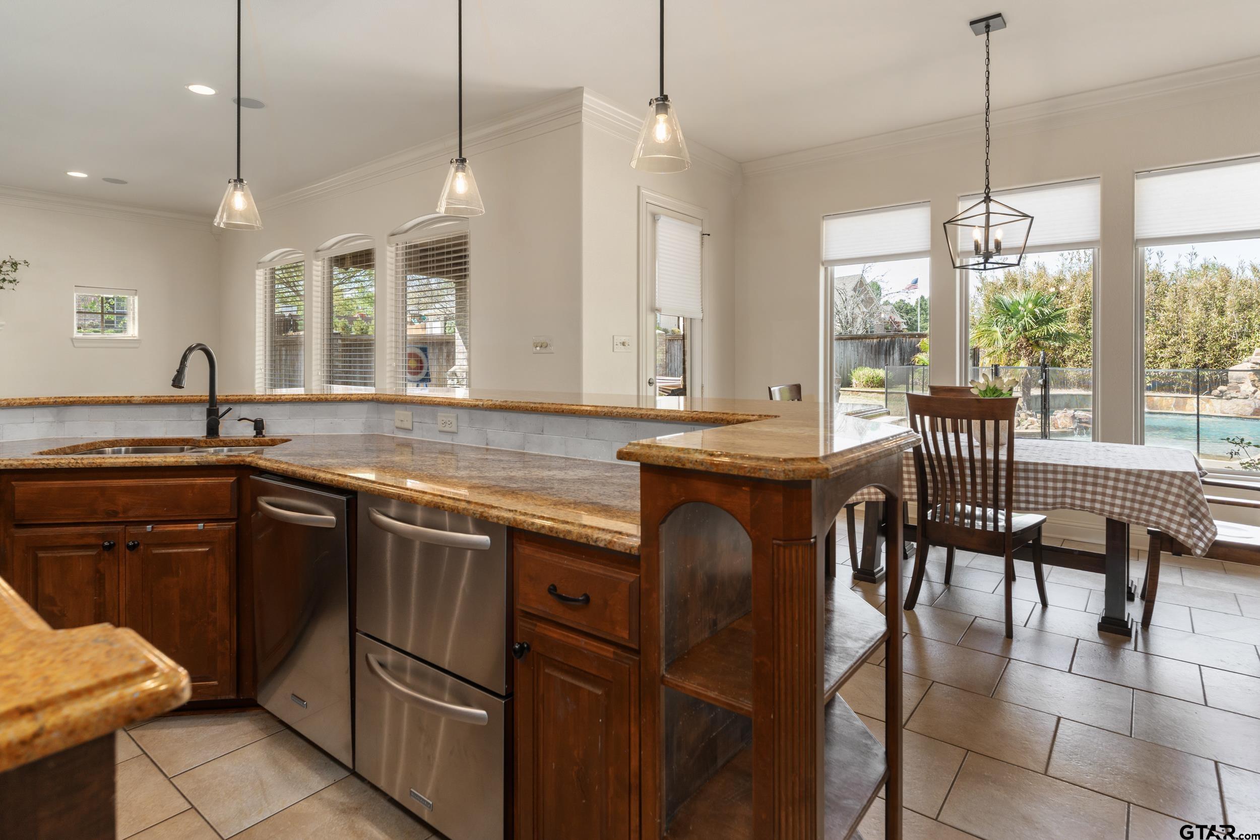 1509 Cooks Crossing Tyler, TX 75703 - Photo 22 of 48 a kitchen with a table chairs sink and cabinets