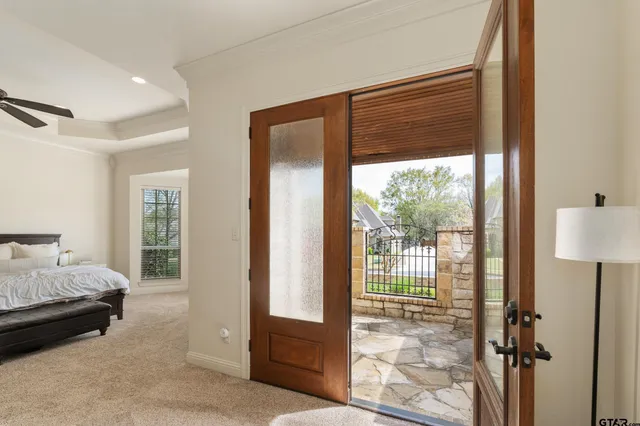 a bedroom with a bed and a large window