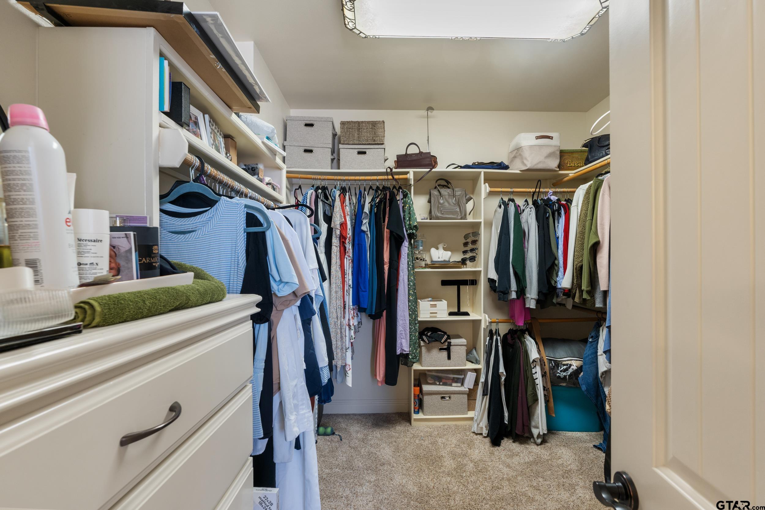1509 Cooks Crossing Tyler, TX 75703 - Photo 33 of 48 a view of walk in closet with clothes and shoes