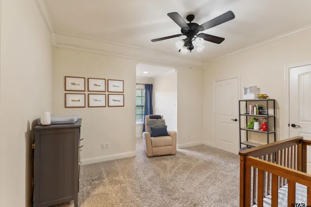 a living room with lots of furniture and baby bed