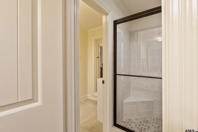 a bathroom with a glass shower door