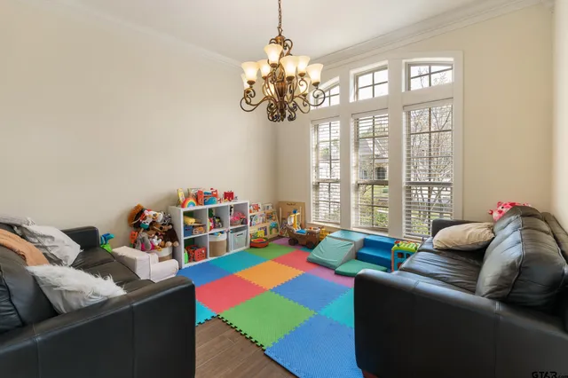 a living room with furniture and a chandelier