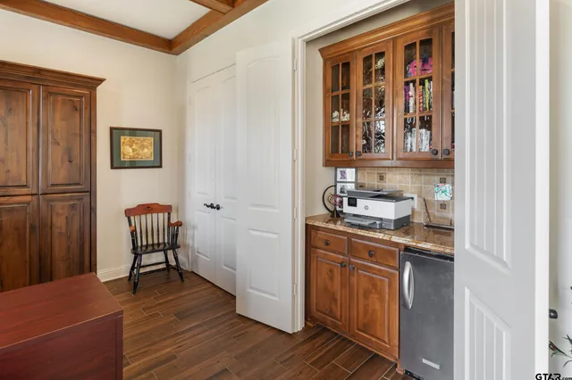 a room with a chair and a window with wooden floor