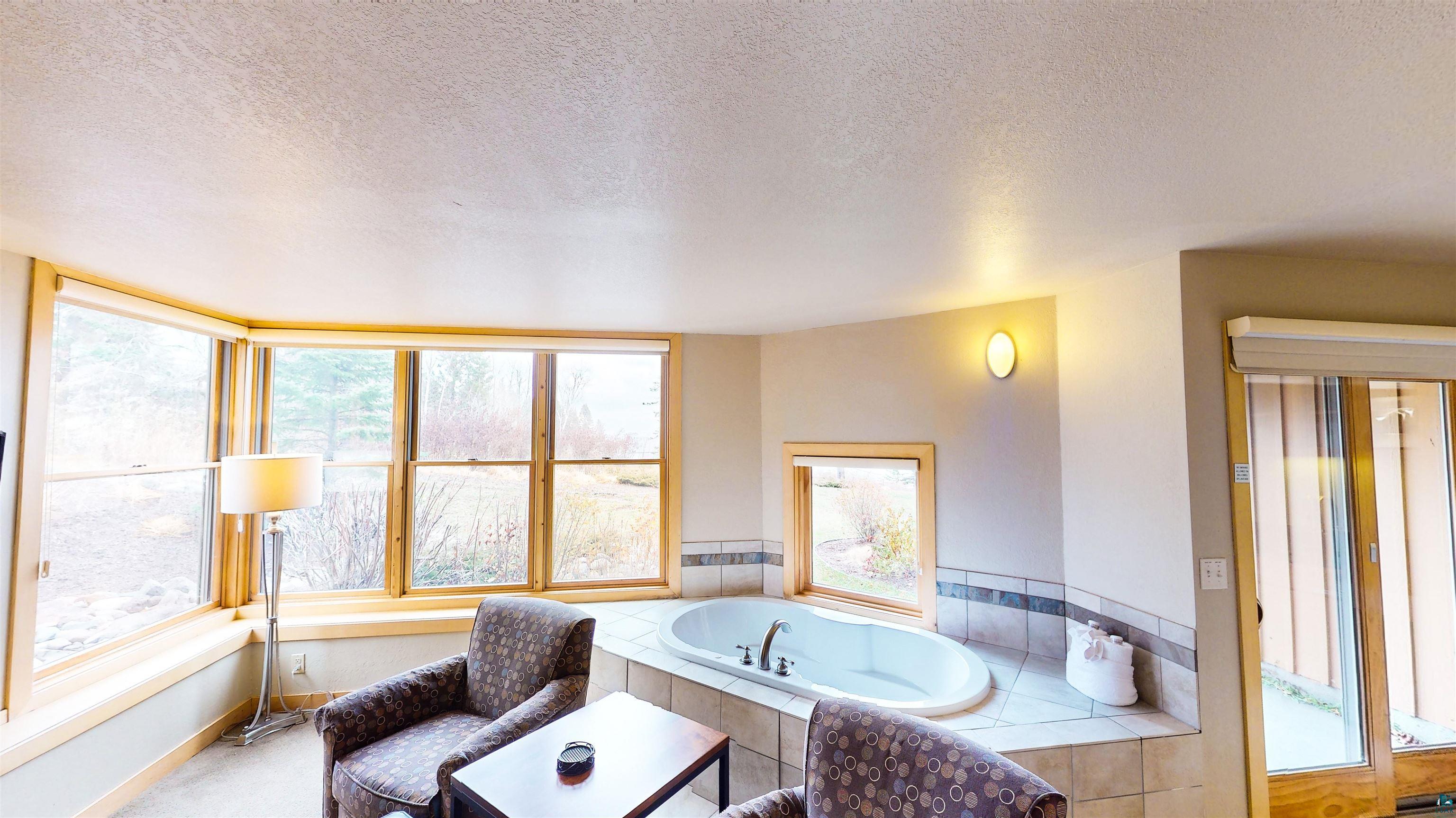 40 Surfside Drive, Unit 5D Tofte, MN 55615 - Photo 24 of 37 Built-in corner soaking tub with tile surround and accent trim