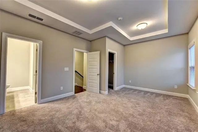 an empty room with closet and windows