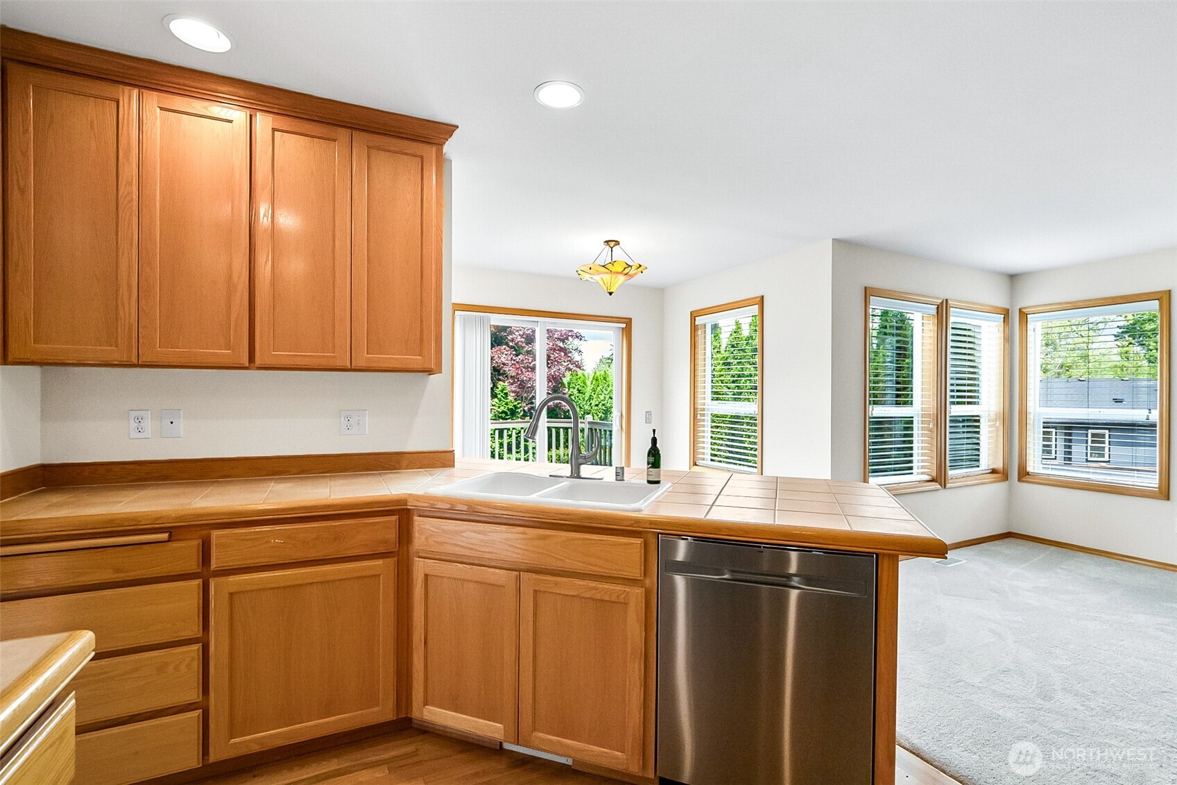 18410 11th Drive Southeast Bothell, WA 98012 - Photo 10 of 40 a kitchen with stainless steel appliances granite countertop a sink and cabinets with wooden floor