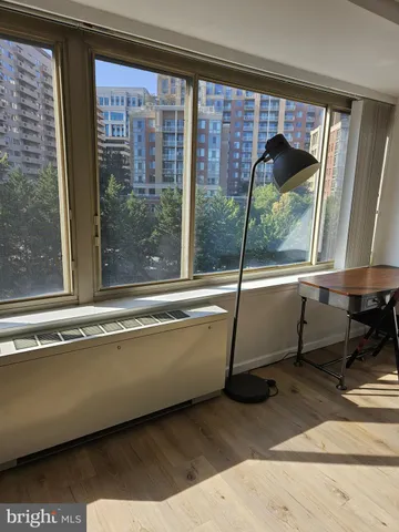 a living room with a large window and furniture