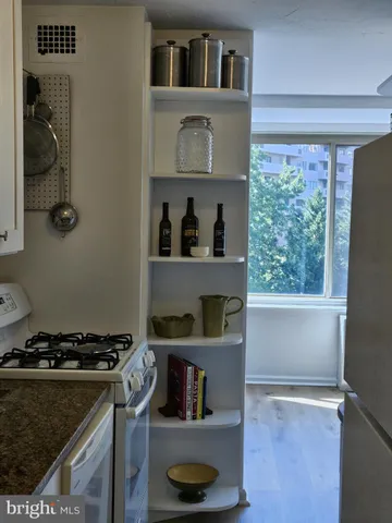 a kitchen with a stove and a refrigerator