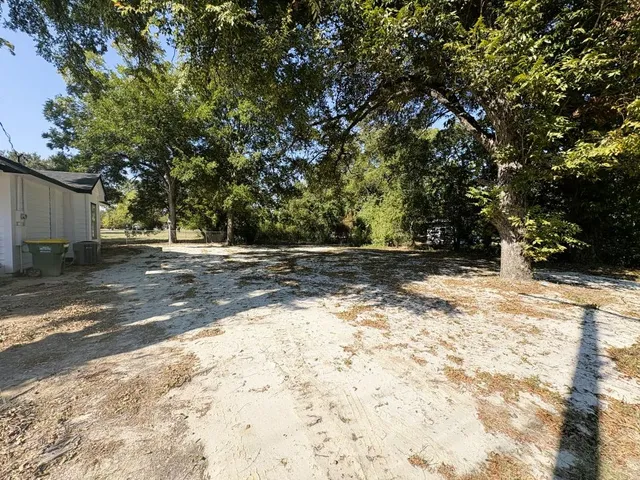 a view of backyard with large trees
