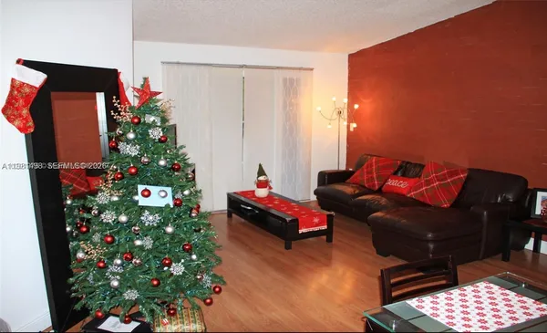 a living room with furniture and flowers