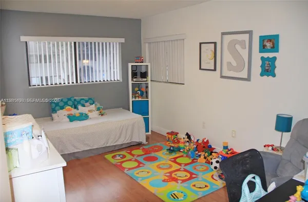 a bedroom with furniture and a wooden floor