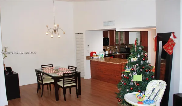 a living room with furniture potted plant and a large window