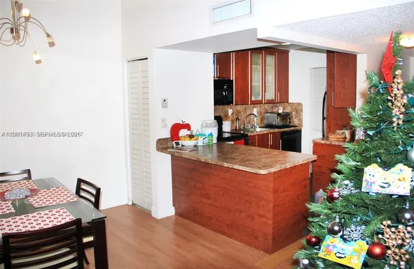 a view of a dining room with furniture and a potted plant