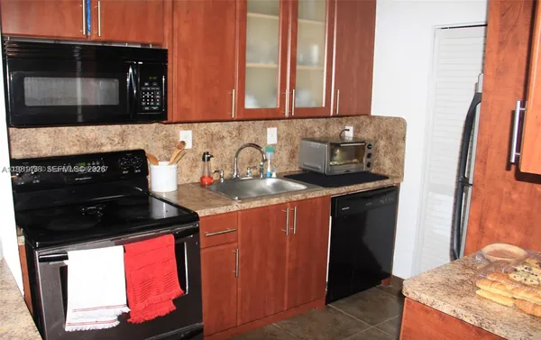 a kitchen with stainless steel appliances granite countertop a stove and a microwave