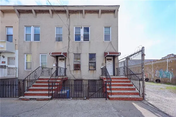 a view of a house with a small yard and stairs